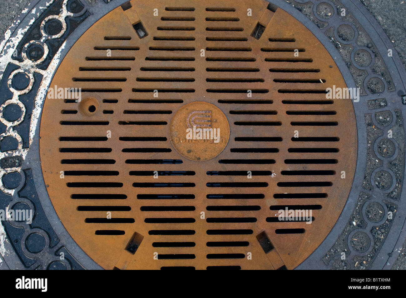 A manhole cover protecting electrical cables Stock Photo