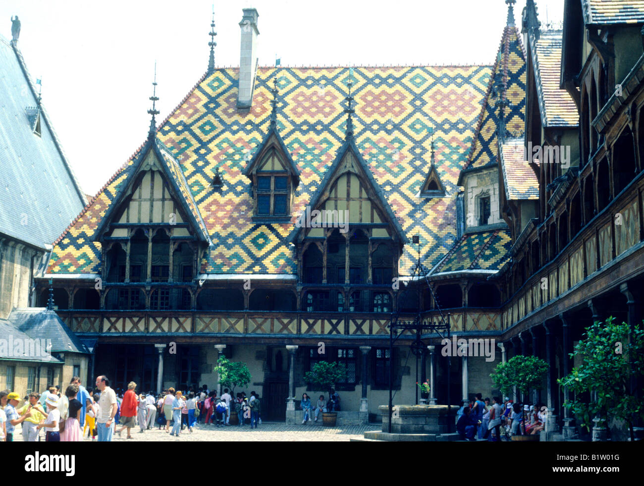 Hotel Dieu Hospice Beaune Burgundy France people coloured slate tiled tiles roof visitors travel French architecture Stock Photo