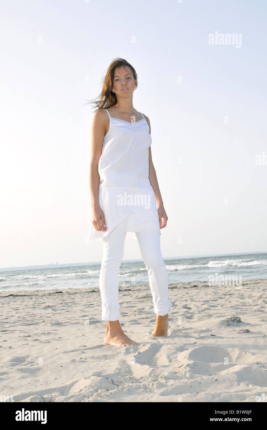 young woman 24 standing and relaxing at beach, backlight, free, easy, happy, holidays, vitality, chillout, backlight, brunette Stock Photo