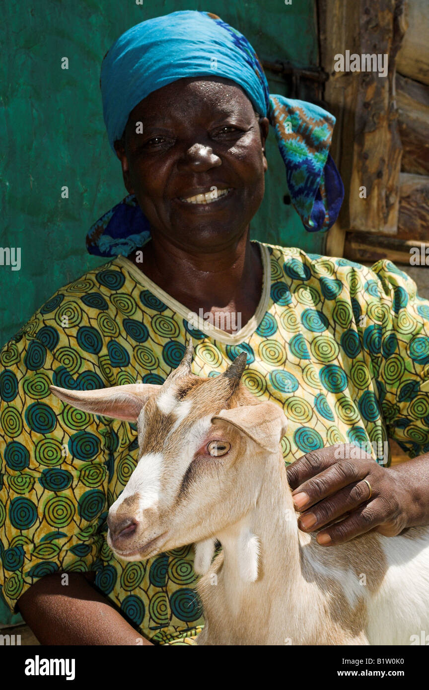 Close up african woman smiling facing camera holding goat Kenya Africa Stock Photo