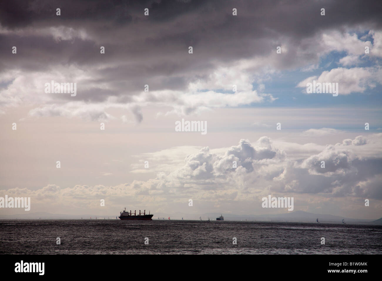 Big dark brooding black storm cloud over the ocean with a big ship and ...