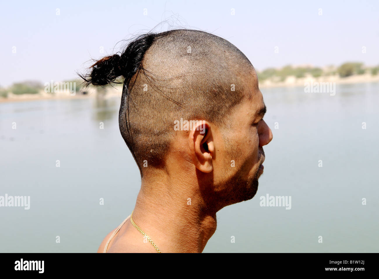 A Brahmin man shows his shaved head. Rajasthan,India Stock Photo