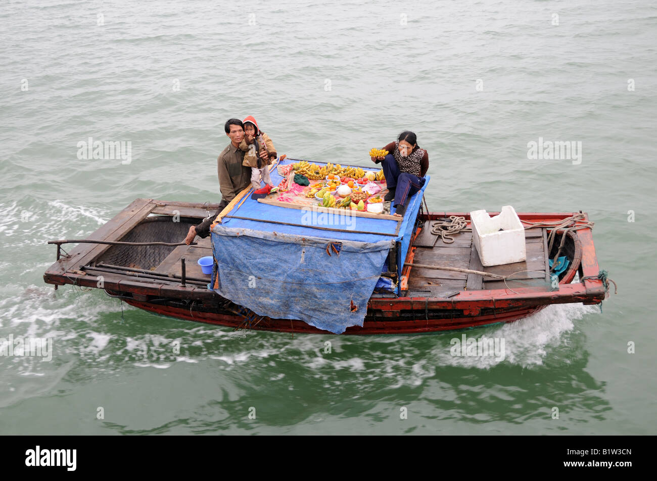 Vietnamese family living and working on a boat Ha long Bay Vietnam Stock Photo