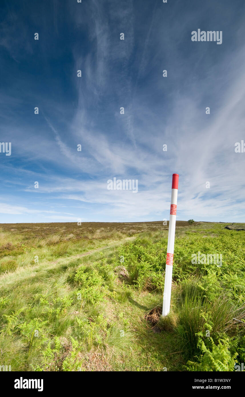 High pressure gas plastic marker post on high moorland in Derbyshire 'Great Britain' Stock Photo