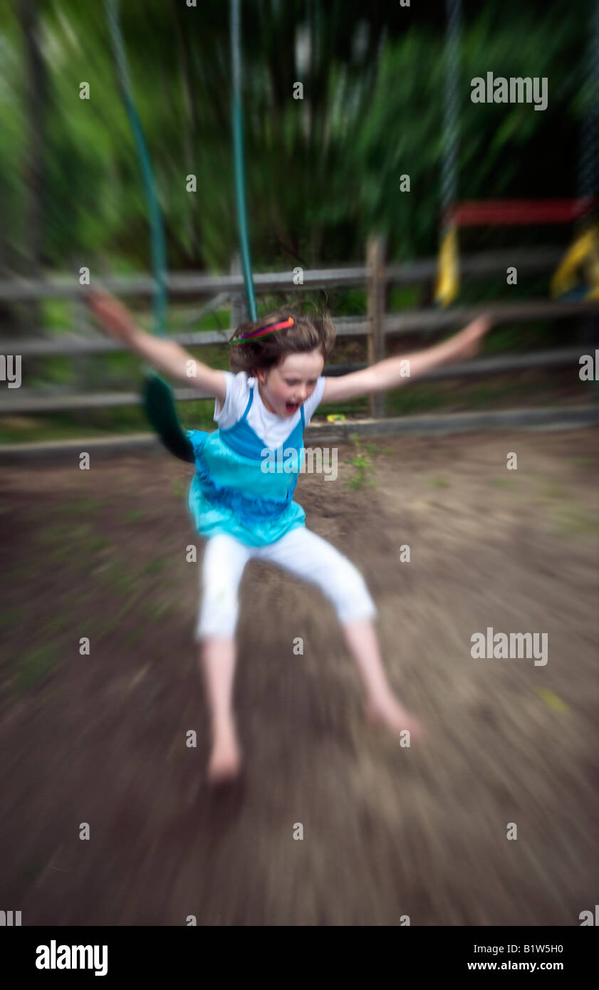 Girl jumping from a swing Stock Photo Alamy