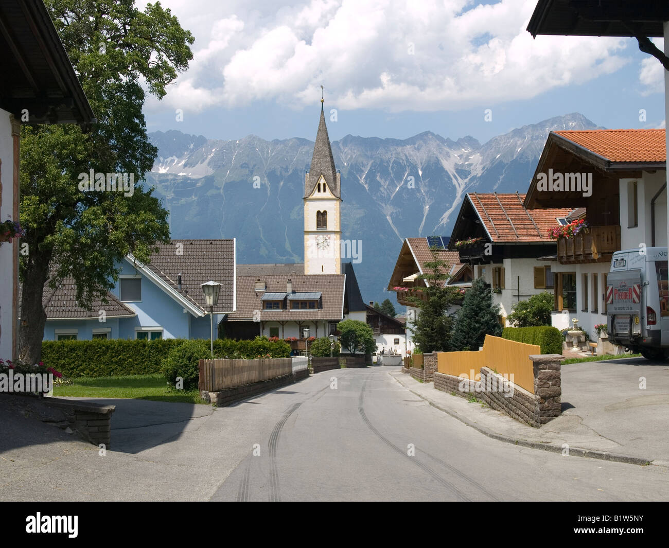 Village street with church in Sistrans Innsbruck Tirol Austria Stock Photo