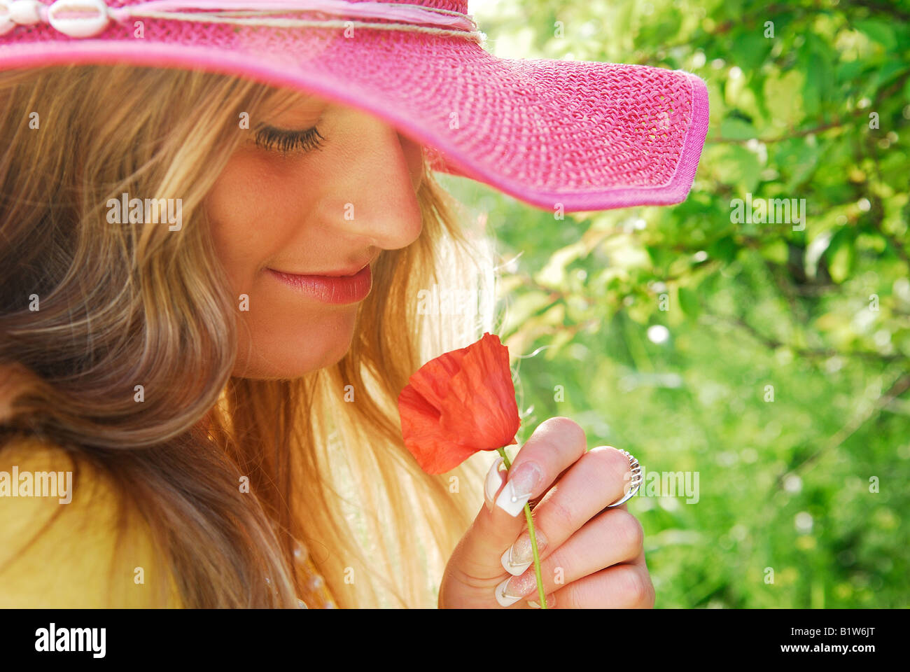 young girl with flower, hat, poppy, girl, young, natural, outdoor, garden, mental health, love for gardening, love story,mind&soul therapy Stock Photo