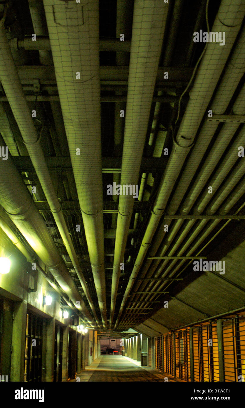 long pipes hanging on ceiling in a tunnel hall hallway corridor industrial  Stock Photo - Alamy