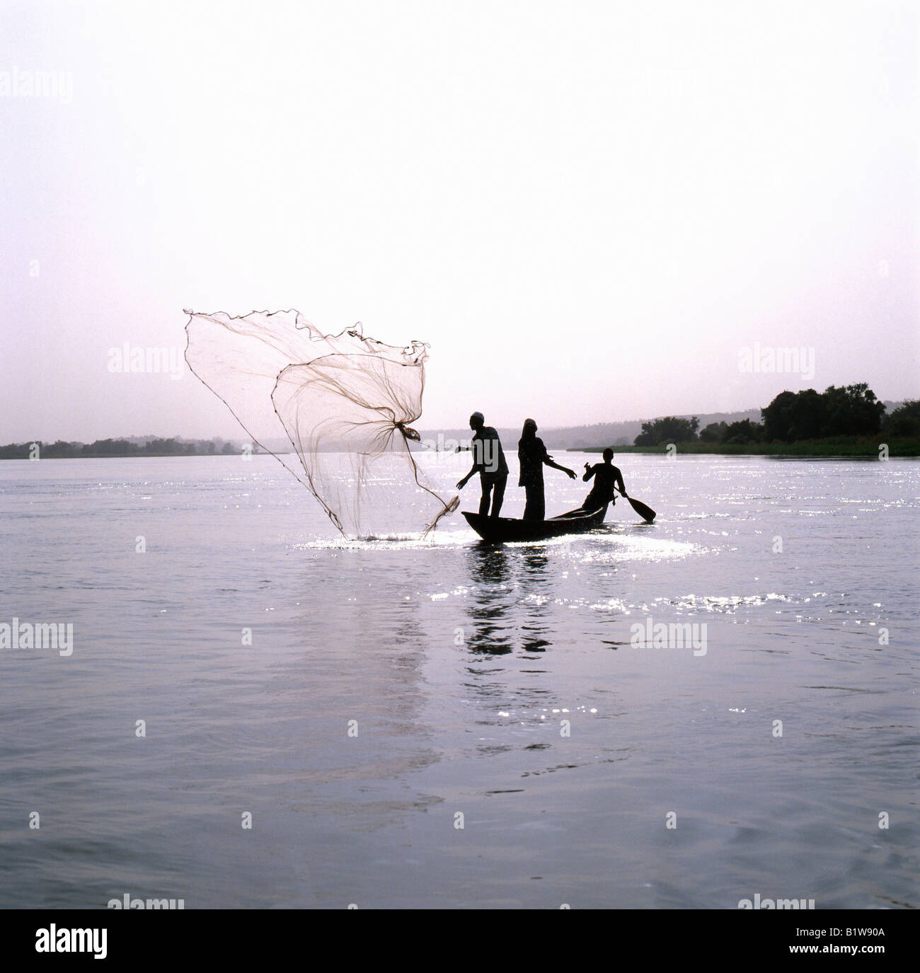 People African men fishing with cast net in the congo River Central