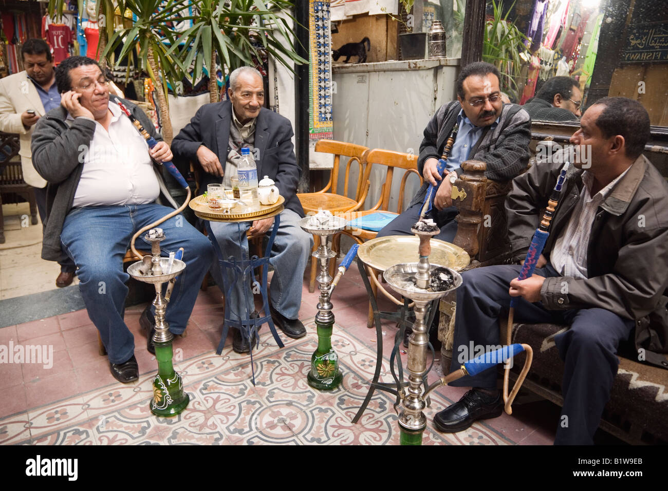 Cairo, Egypt, Africa. Fishawi s coffeehouse in Khan al Khalili market. Men smoking water pipes Stock Photo