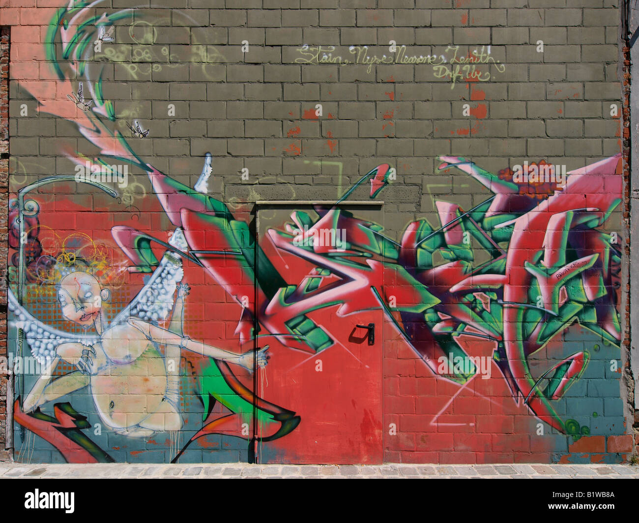 Interesting graffiti art on wall with door Antwerp Flanders Belgium Stock Photo