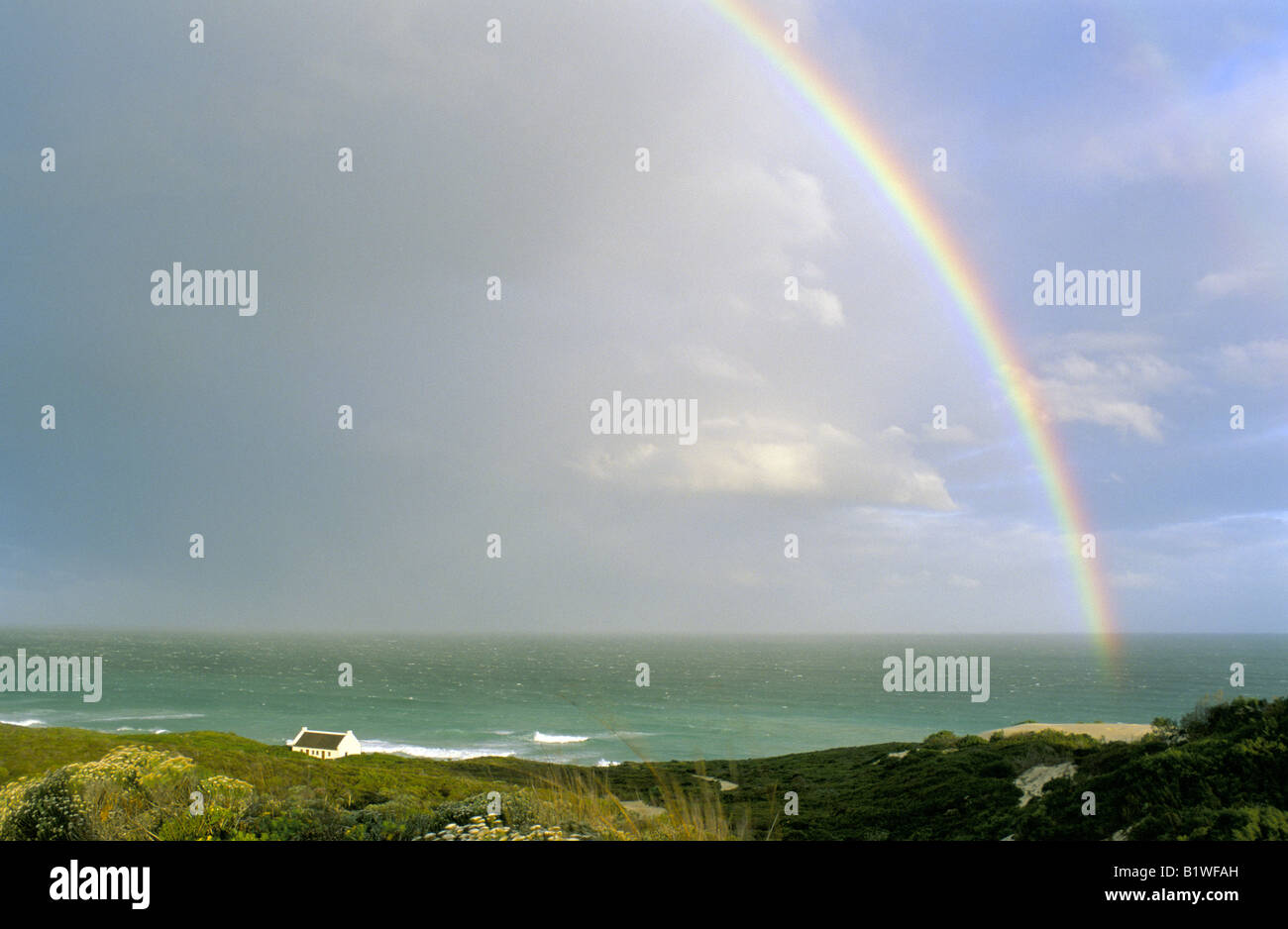 View of a rainbow over De Hoop nature reserve Overberg,Cape coast after an afternoon rain shower. Stock Photo