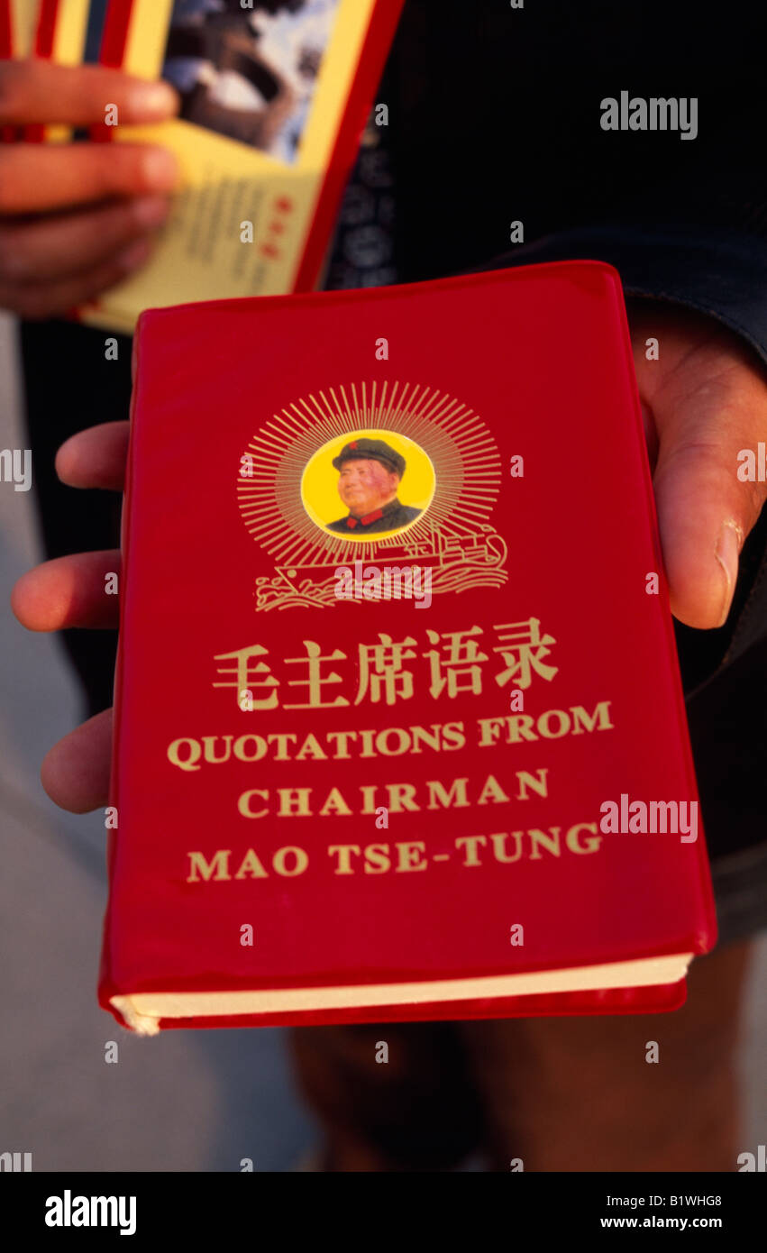 CHINA Asia Shanghai Tiananmen Square Person holding copy of the Thoughts of Chairman Mao Tse-Tung or Mao Zedong Little Red Book Stock Photo
