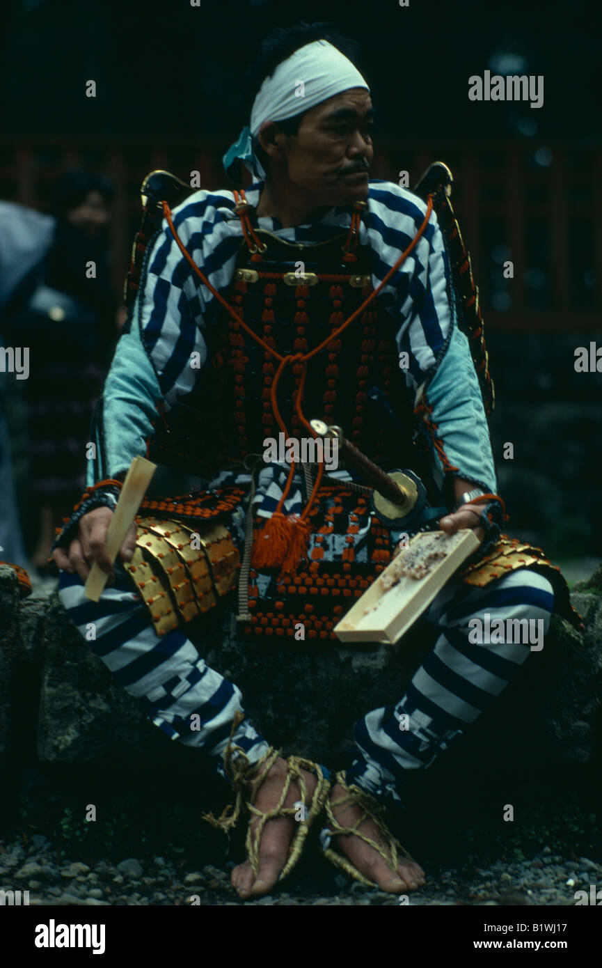 Japan Portrait of Samurai warrior wearing armour constructed of plates of metal or bamboo held together with coloured lacing Stock Photo