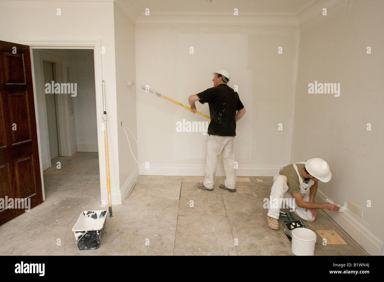 Decorators painting a room Stock Photo Alamy