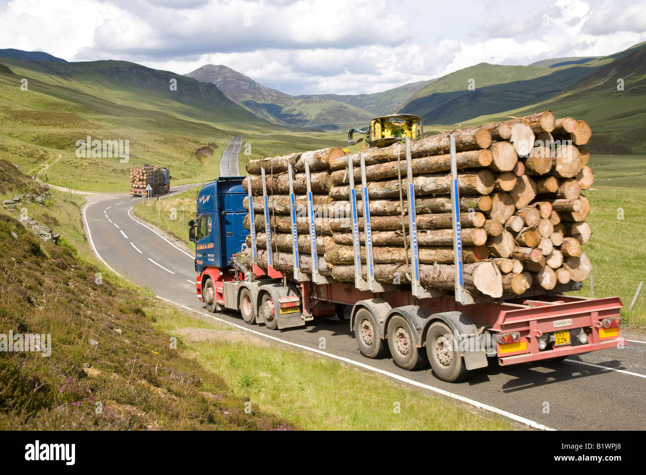 Braemar A93 Scottish timber industry, logging truck, cut logs, heavy haul road transport on a mountain road,  Cairngorms National Park, Scotland, UK Stock Photo