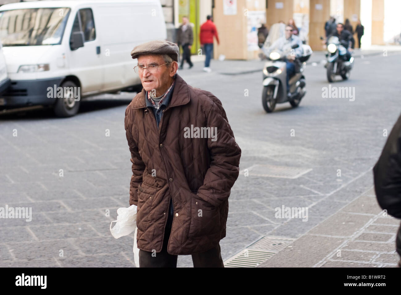 Elderly man walks along a street in Catania, Sicily, Italy Stock Photo