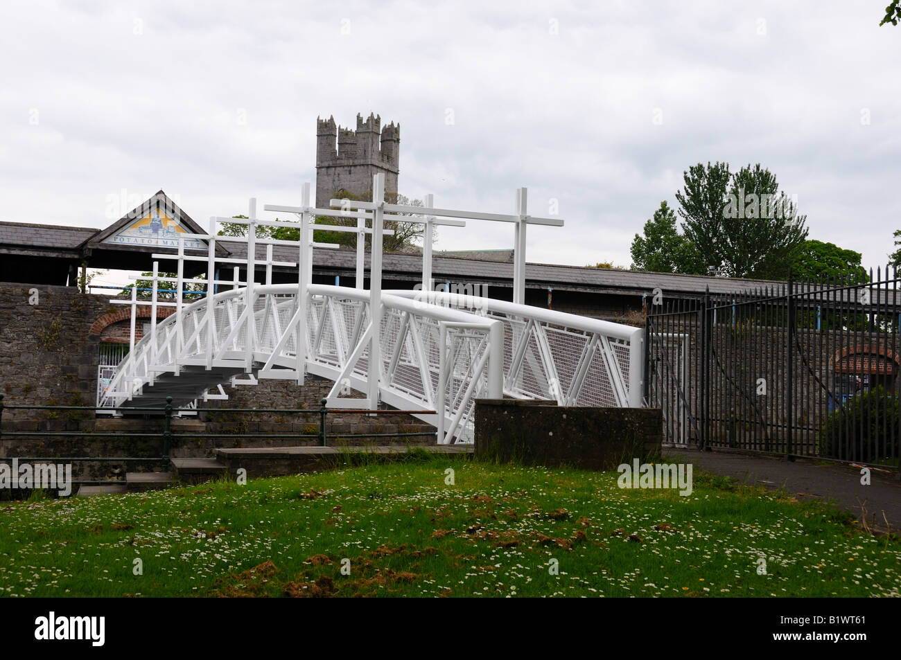 A white pedestrian bridge leads to the St. Mary's Cathedral. Limerick, Ireland. Stock Photo