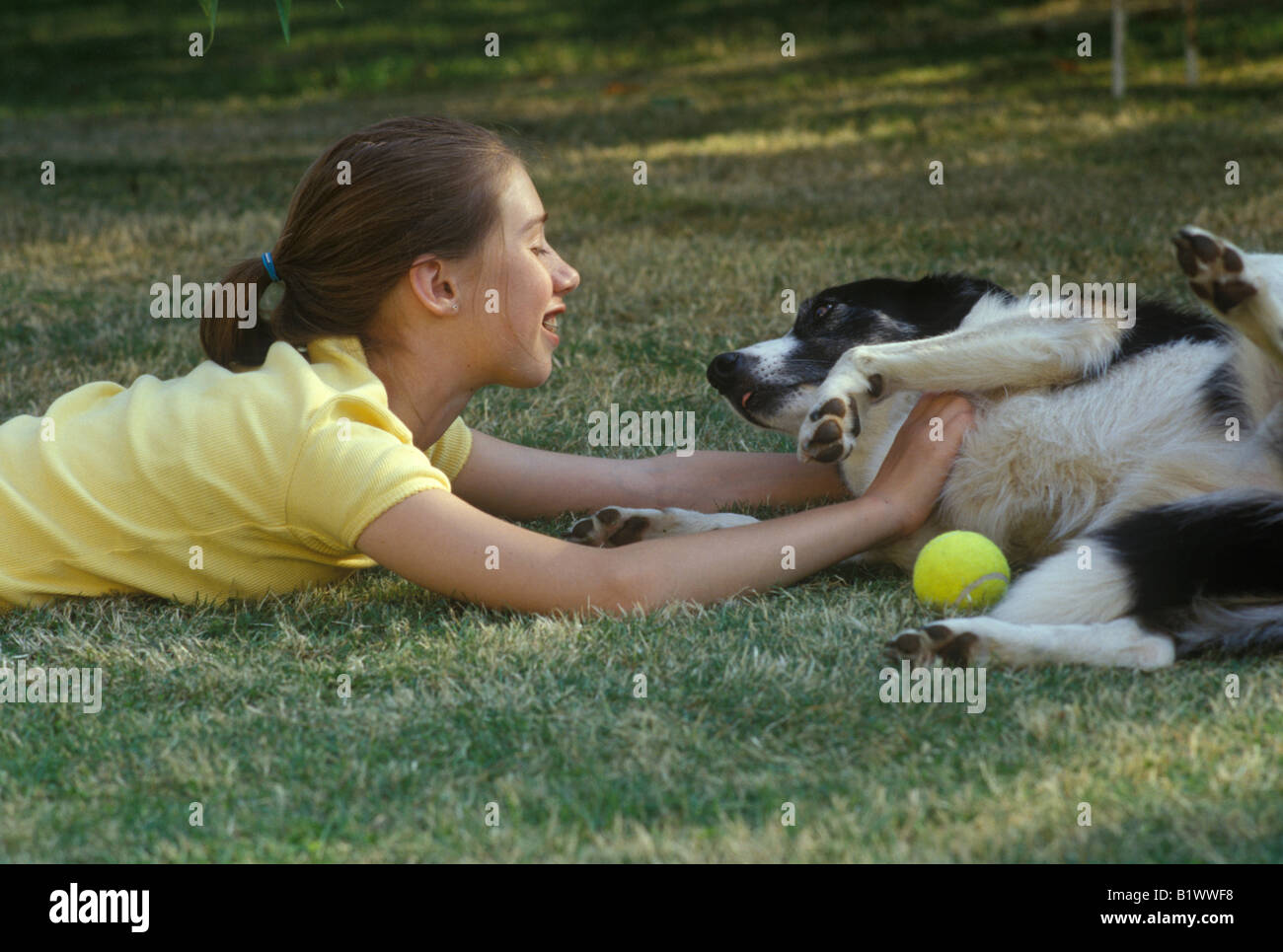young girl playing in the garden with her dog Stock Photo - Alamy