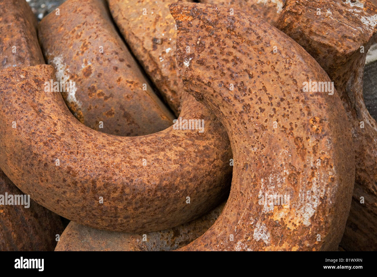 Broken and rusting iron circles waiting to be recycled Stock Photo Alamy
