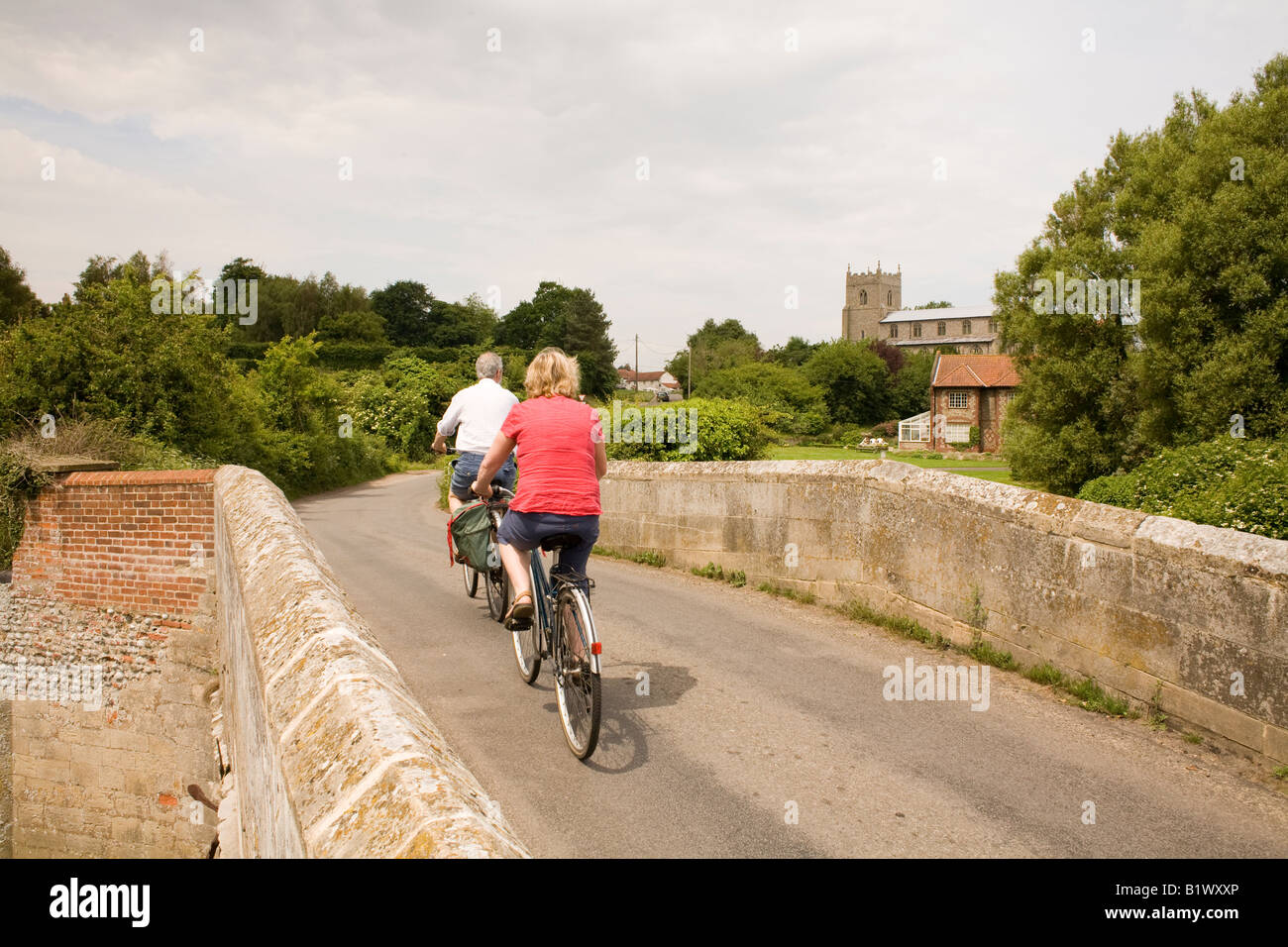 Two cyclists on a bridge near Wiveton in Norfolk Stock Photo - Alamy