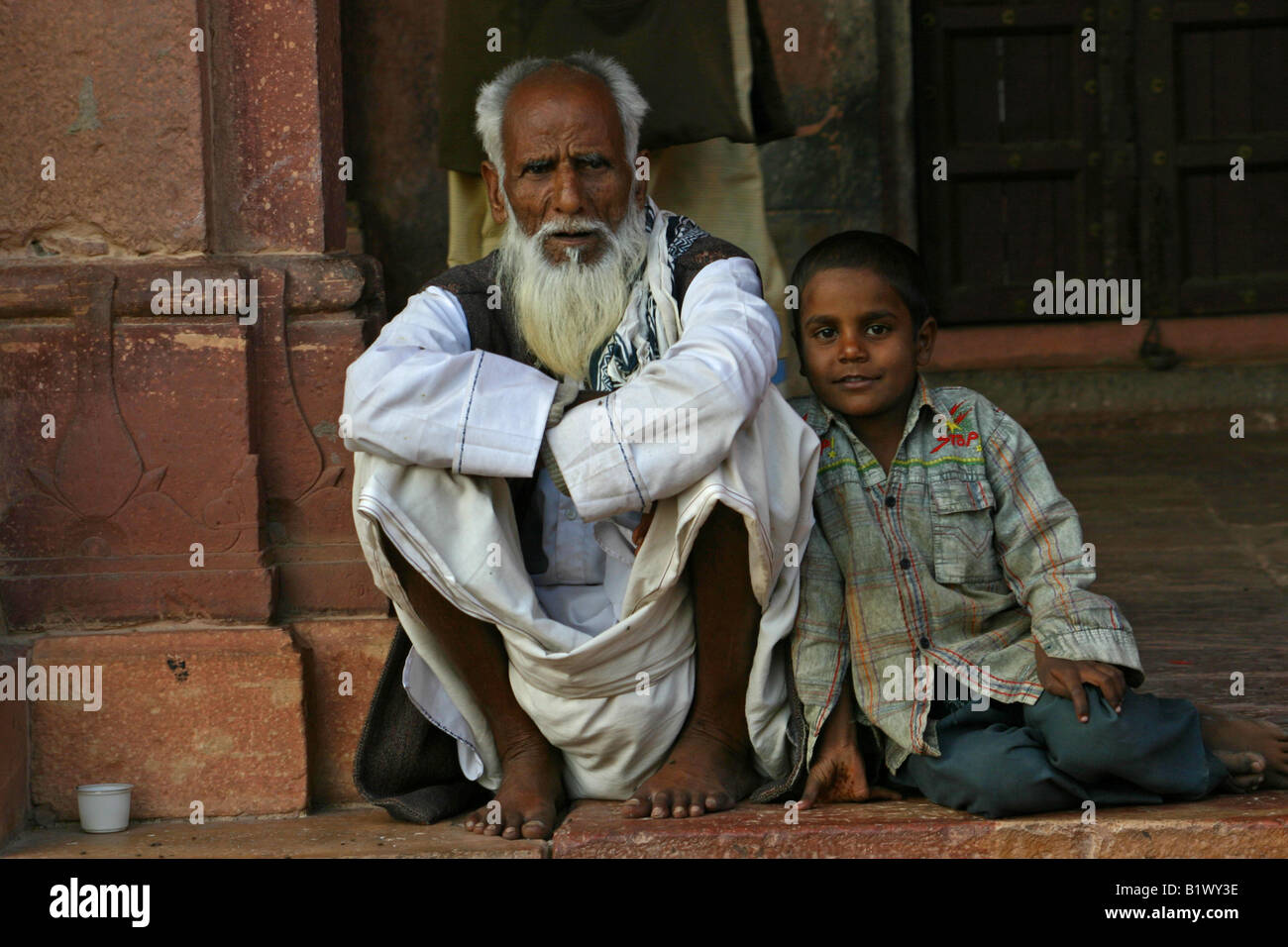 Young boy and elderly man in fatehpur sikri Stock Photo