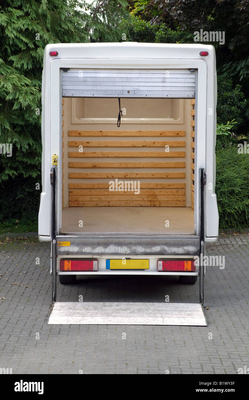 Rear view of an empty white box van with it s tail lift lowered Stock Photo