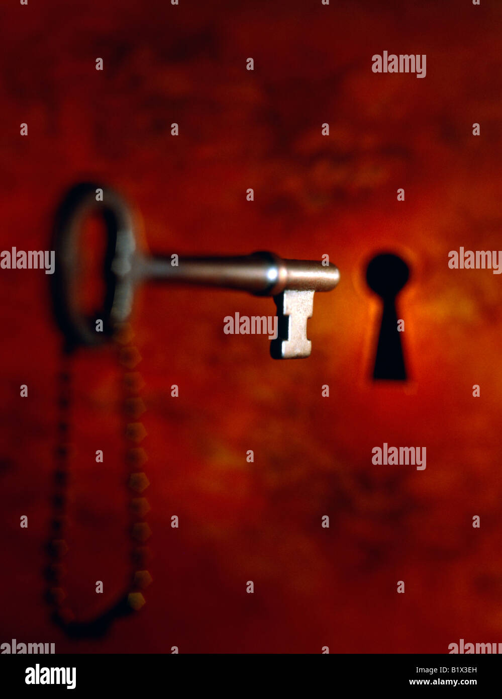 brass skeleton key with chain and keyhole Stock Photo Alamy