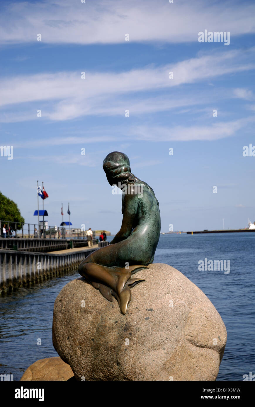 The Little Mermaid Gazes towards the cruise ship dock of Langelinie Stock Photo
