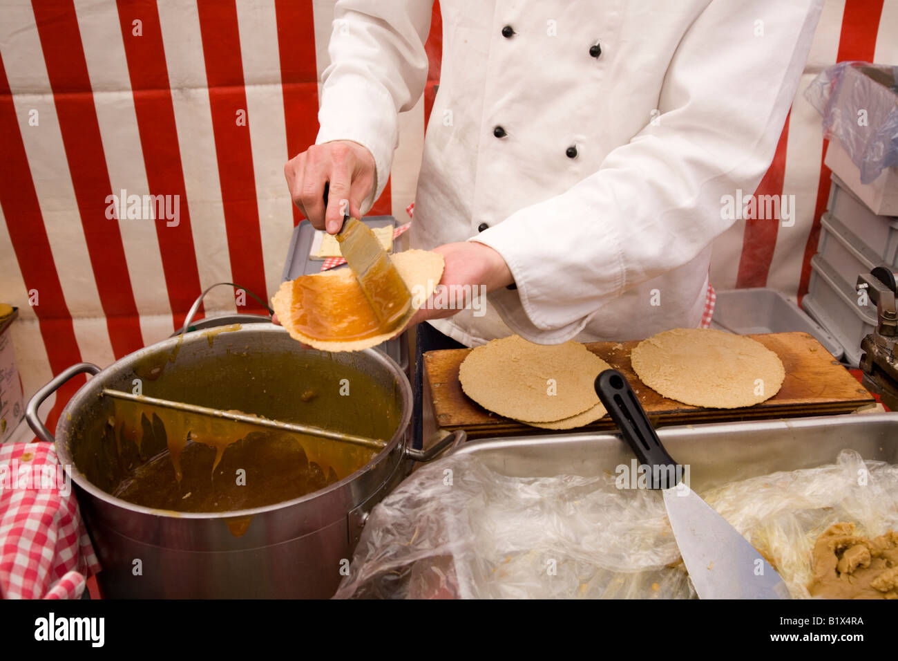 Jam being spread onto a Dutch waffle at a waffle stall in Delft, Netherlands. Stock Photo