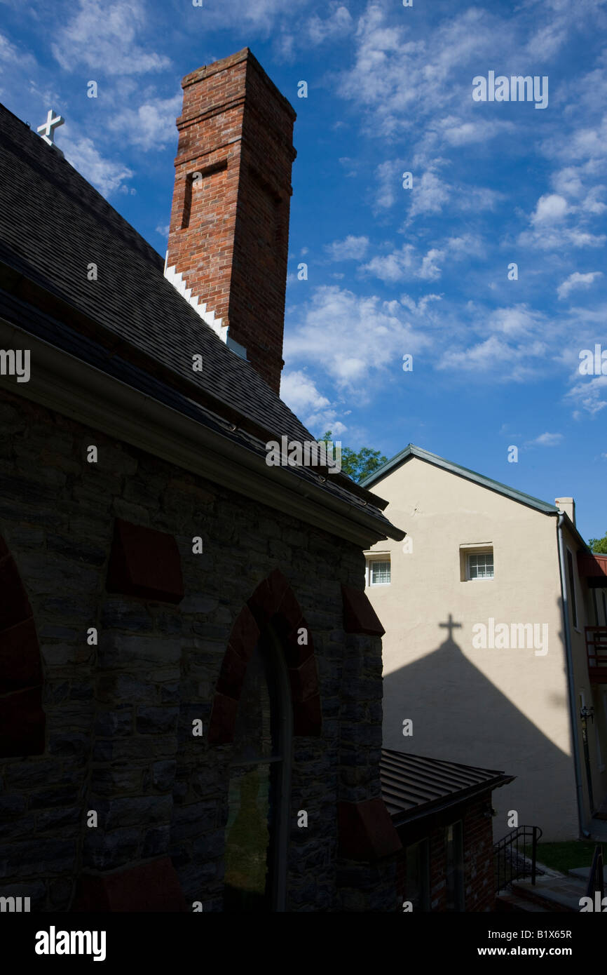Shadows from a cross atop St. Peter's Church are cast on the side of an adjacent building Harpers Ferry National Historical Park Stock Photo