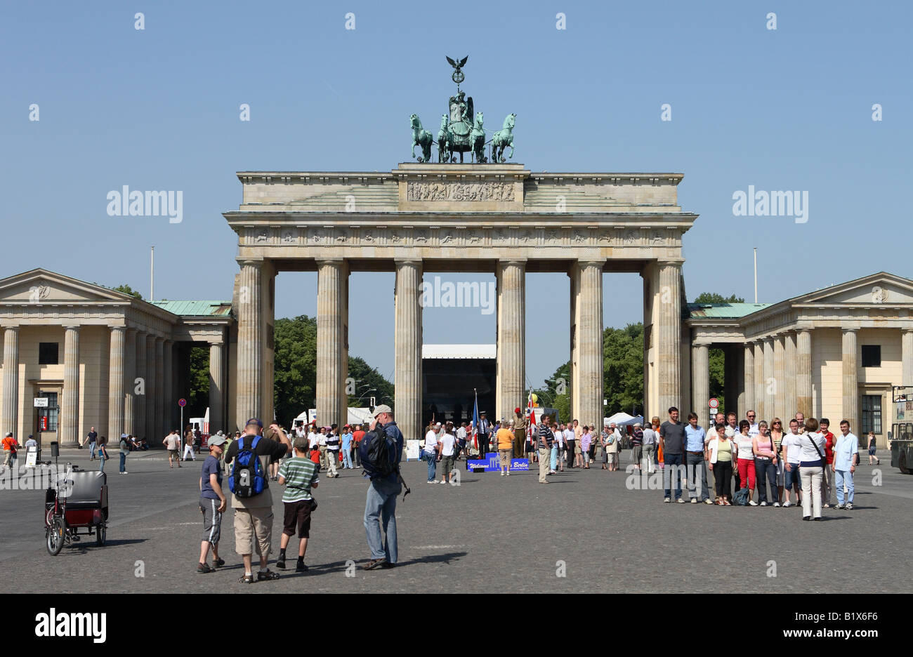 Berlin Germany the historic Brandenburg Gate in the Pariser Platz crowned by the Quadriga scupture with many tourists Stock Photo