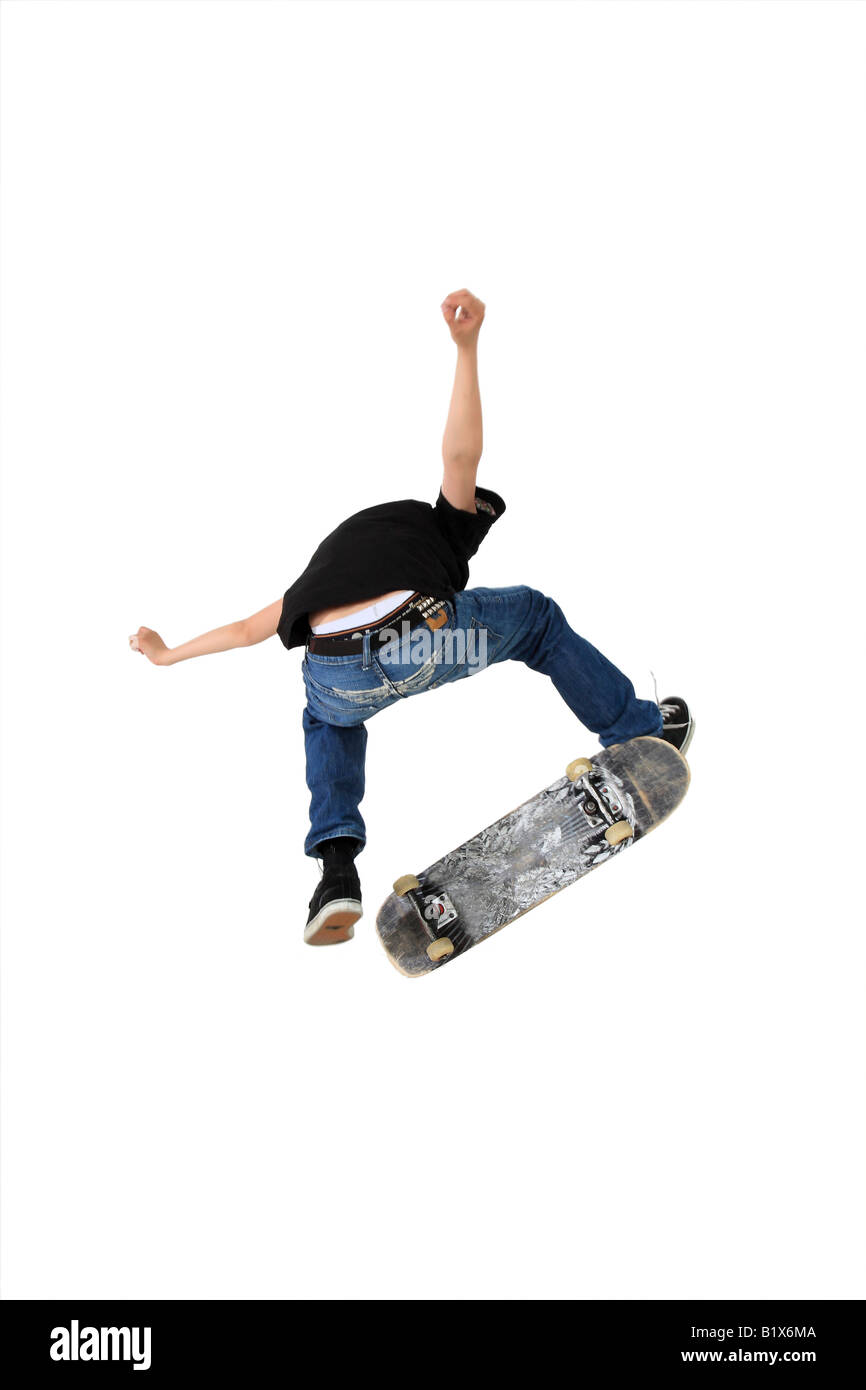 Skateboarder doing a kickflip with his board Shot in studio and isolated on white with some motion blur Stock Photo