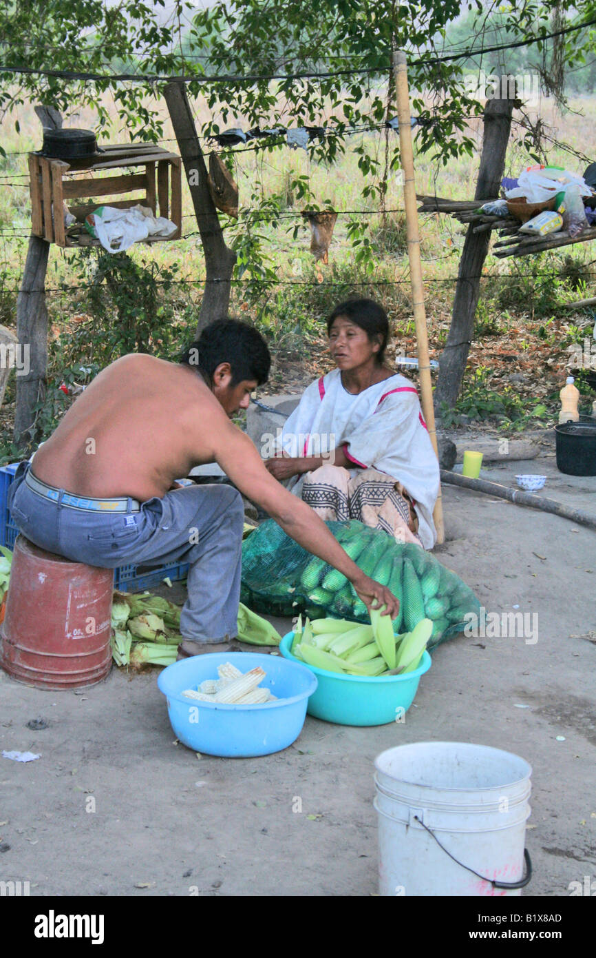 A indigenous Mexican couple shucking corn for dinner Stock Photo - Alamy