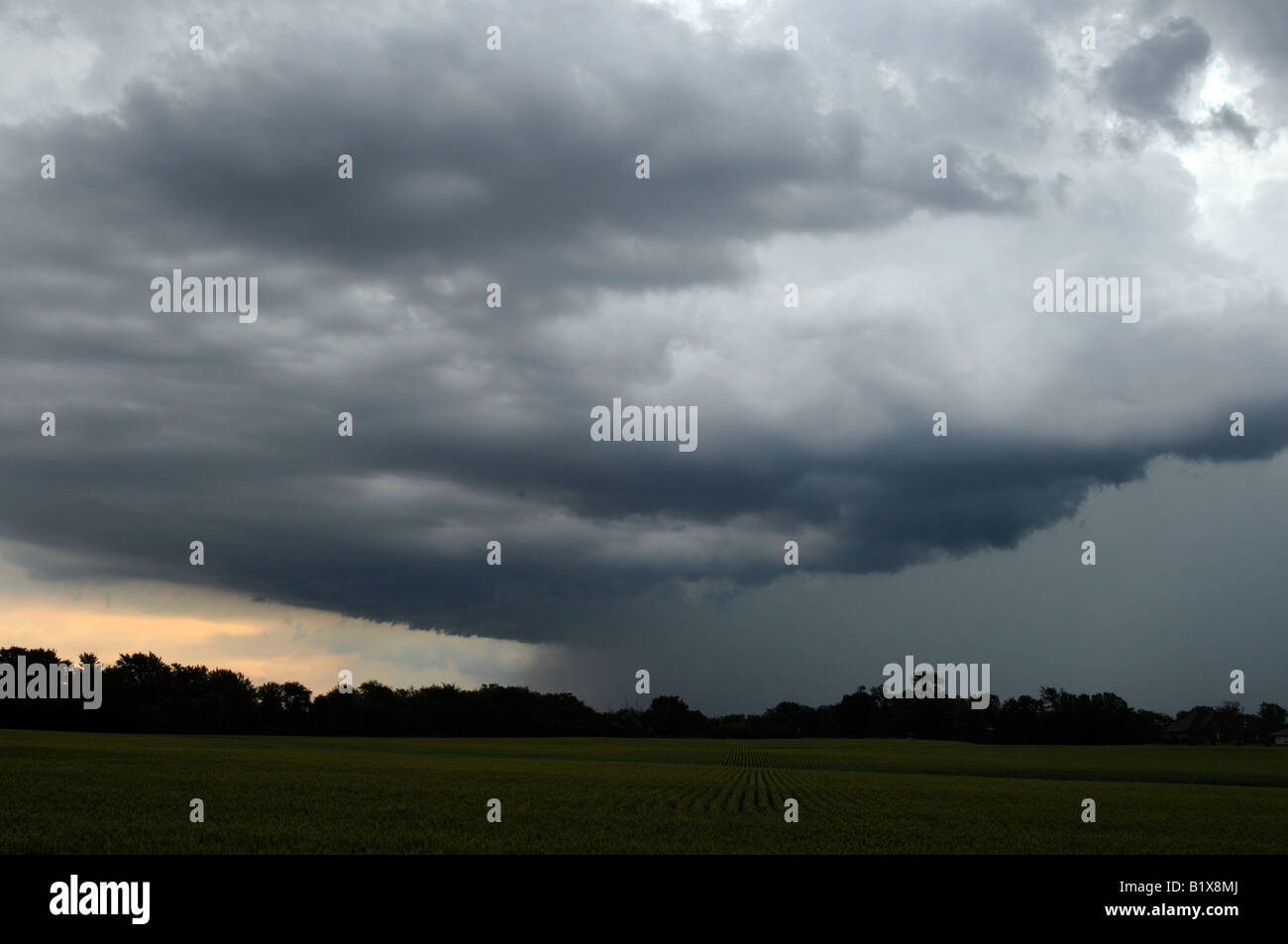 A thunderstorm rolls over a farm in the midwestern United States. Stock Photo