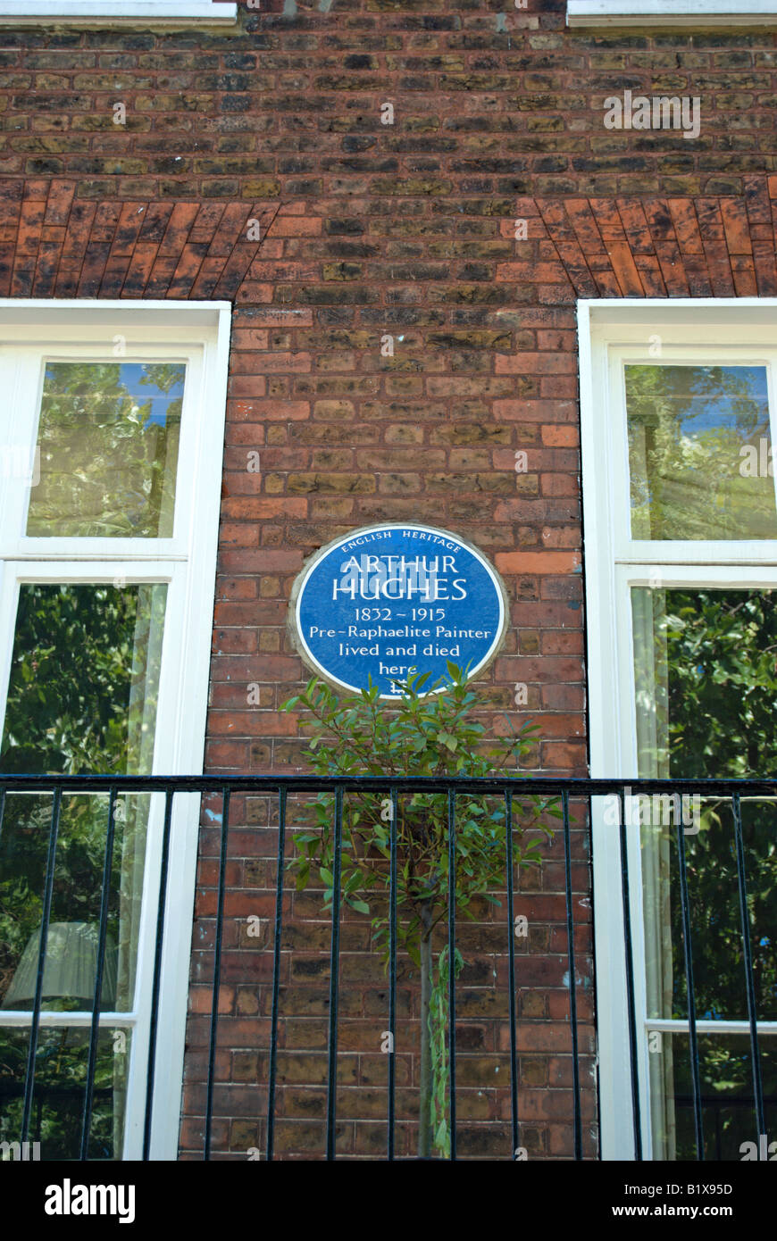 english heritage blue plaque marking a former home of  painter arthur hughes, kew green, southwest london, england Stock Photo