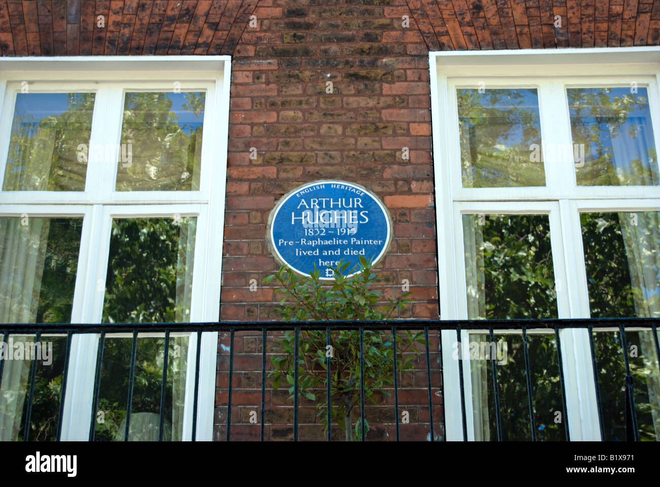 english heritage blue plaque marking a former home of  painter arthur hughes, located on kew green, southwest london, england Stock Photo