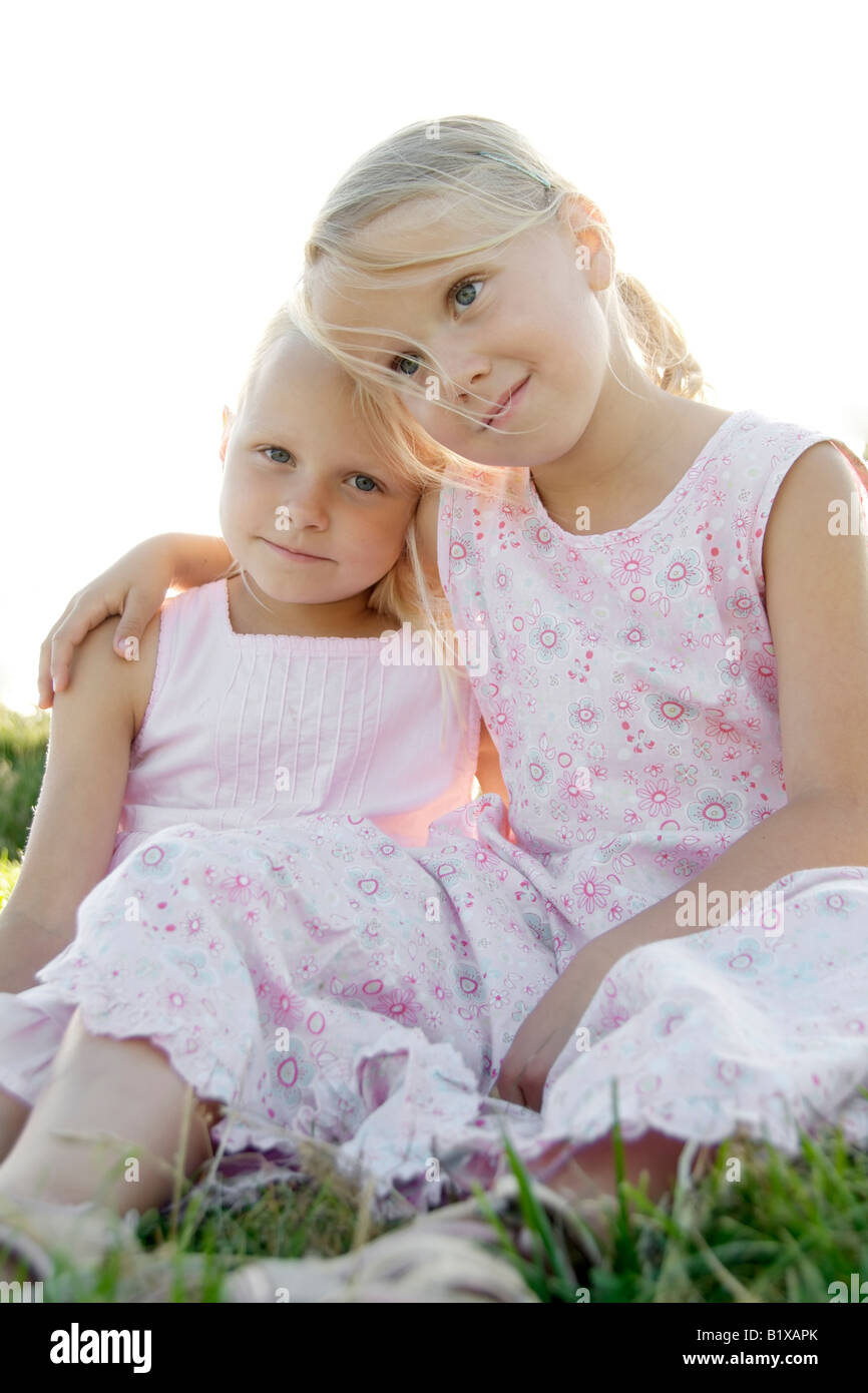 Portrait of two girl friends putting their arms around their shoulders in summer, outdoor exterior Stock Photo