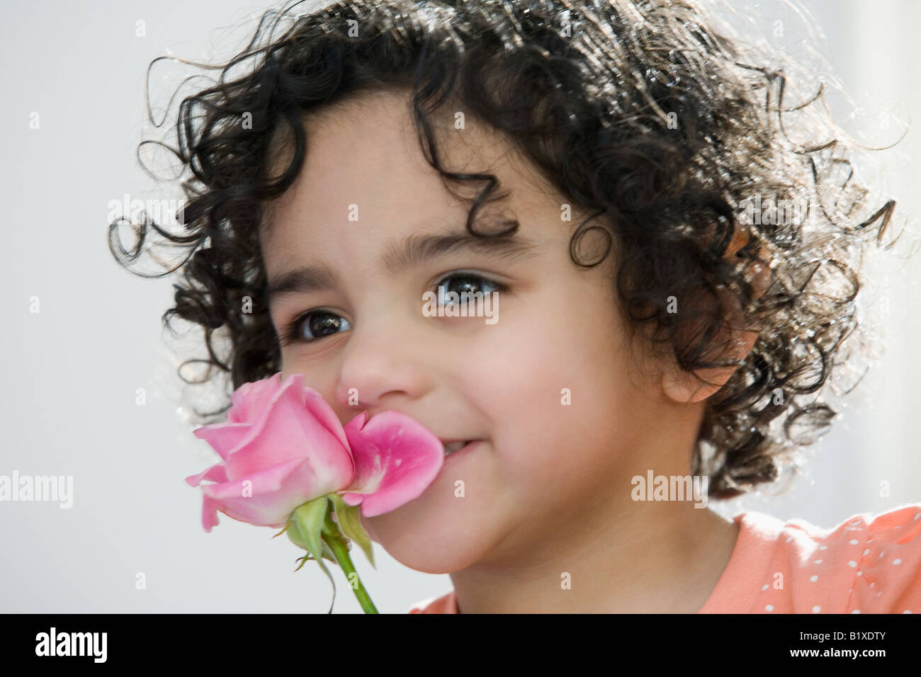 Black child smelling flower hi-res stock photography and images - Alamy