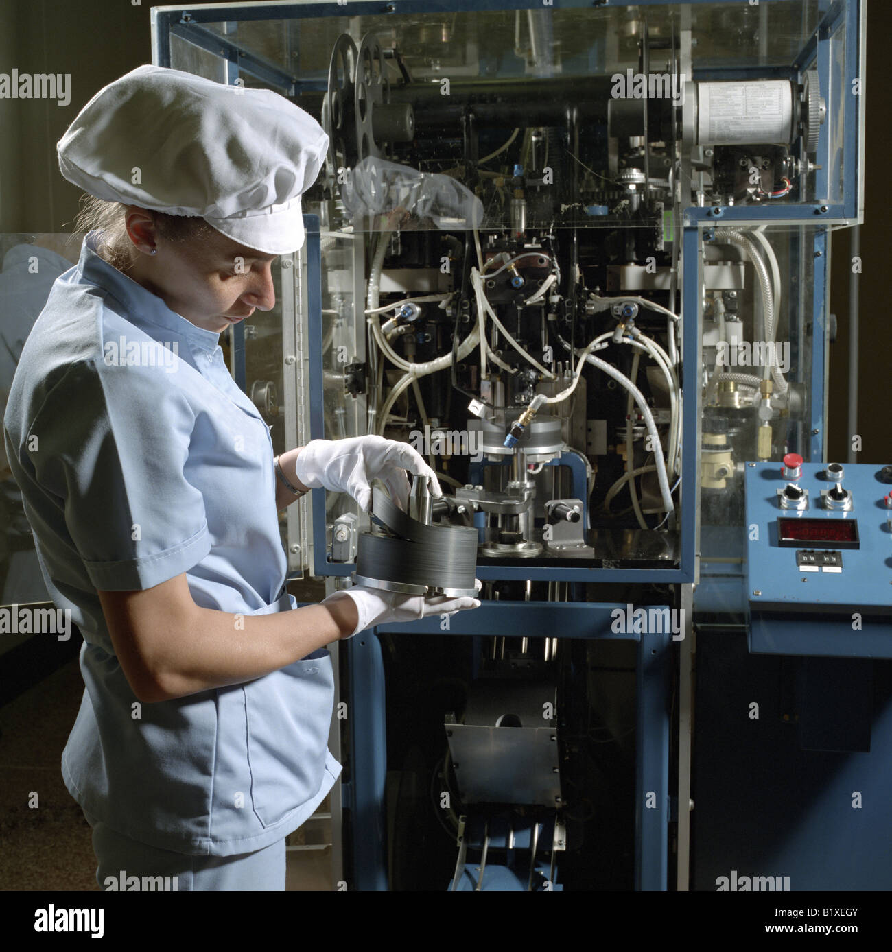 Operator Inspecting Magnetic Disks Stock Photo
