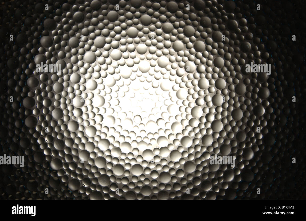 A round glowing spotlight section of glass bubbles. Stock Photo