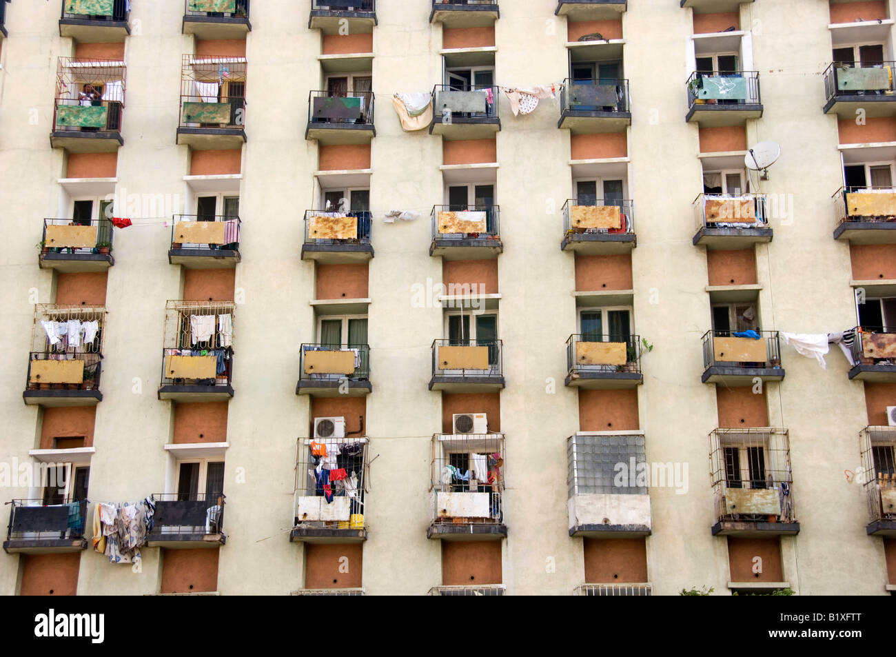 Rows and lines of modified balconies on decayed high rise building ...