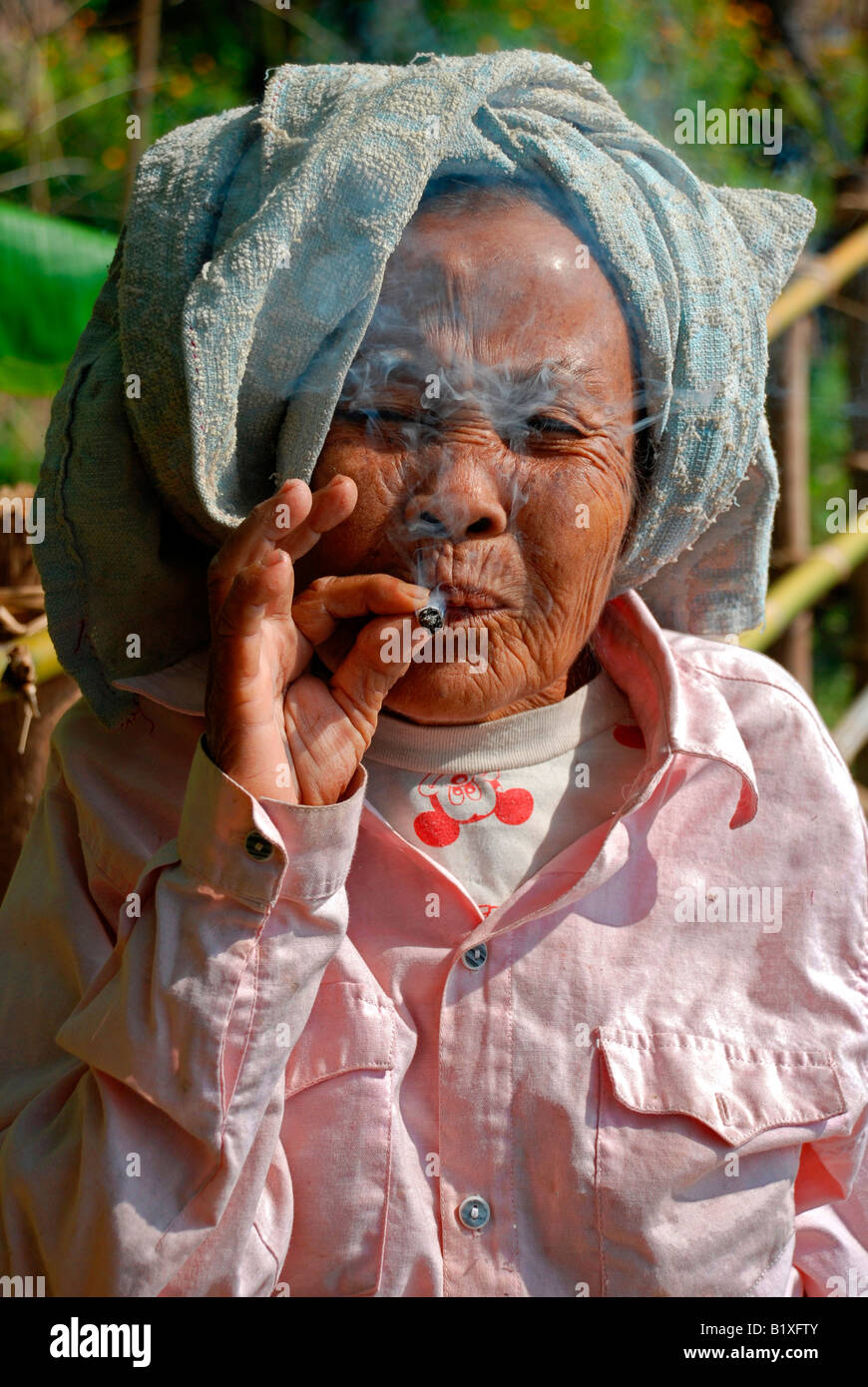 Old Lao woman smoking, portrait Stock Photo