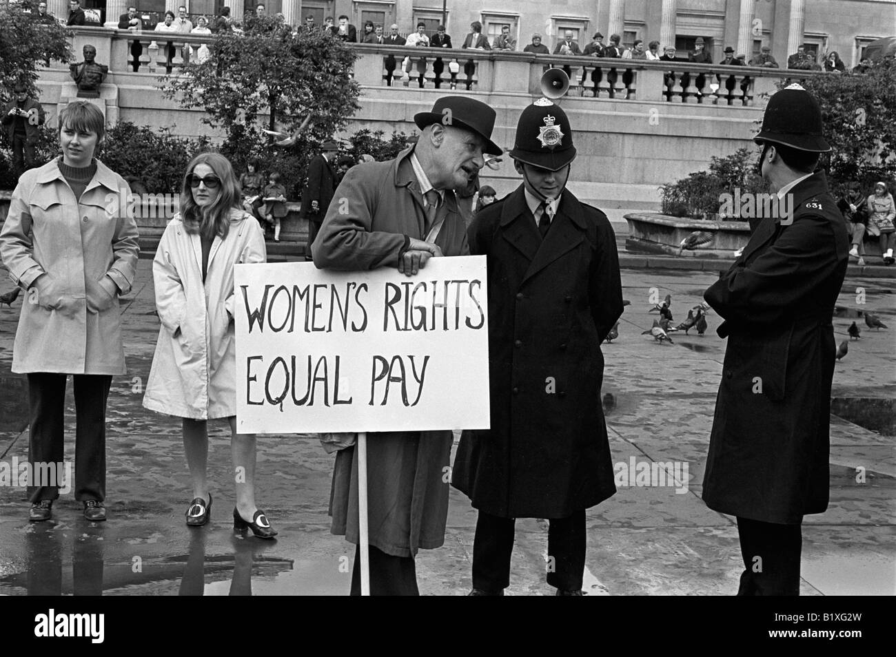 Women Rights 1960s UK. Equal Rights Equal Pay, man with placard talking to police on duty 1968 HOMER SYKES Stock Photo