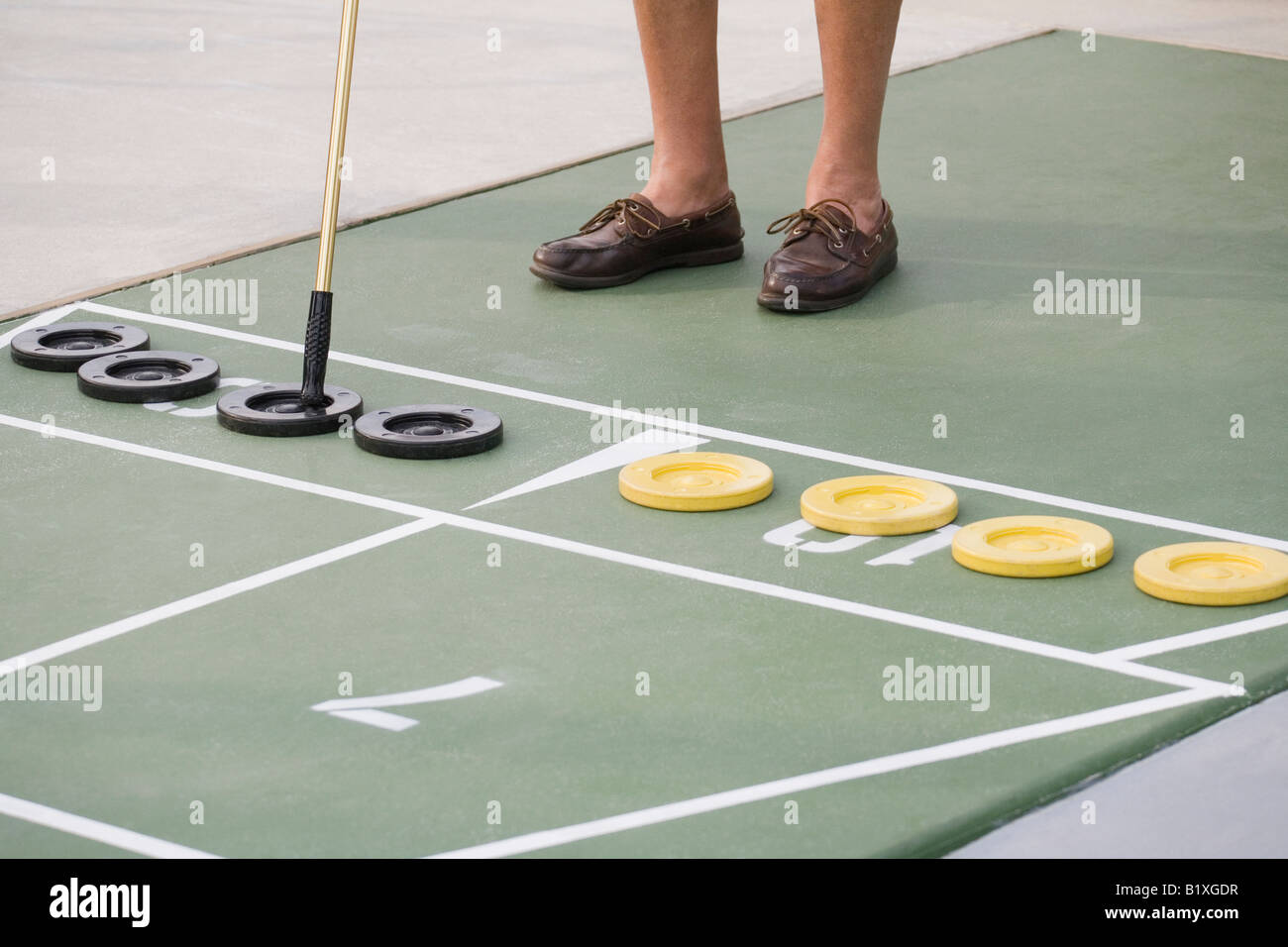 Low section view of a senior man playing shuffleboard Stock Photo Alamy