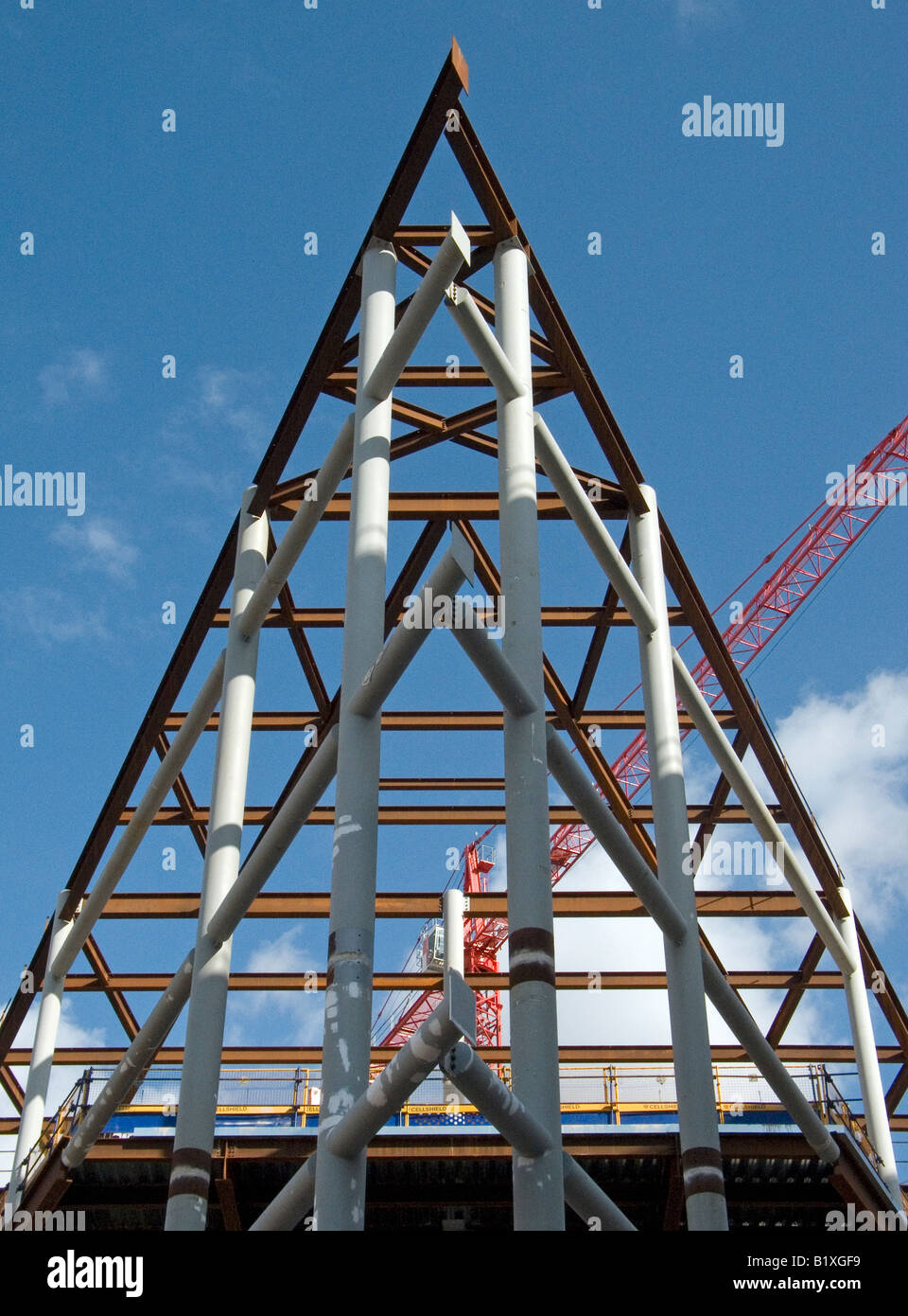 steel framed building under construction against a blue sky Stock Photo