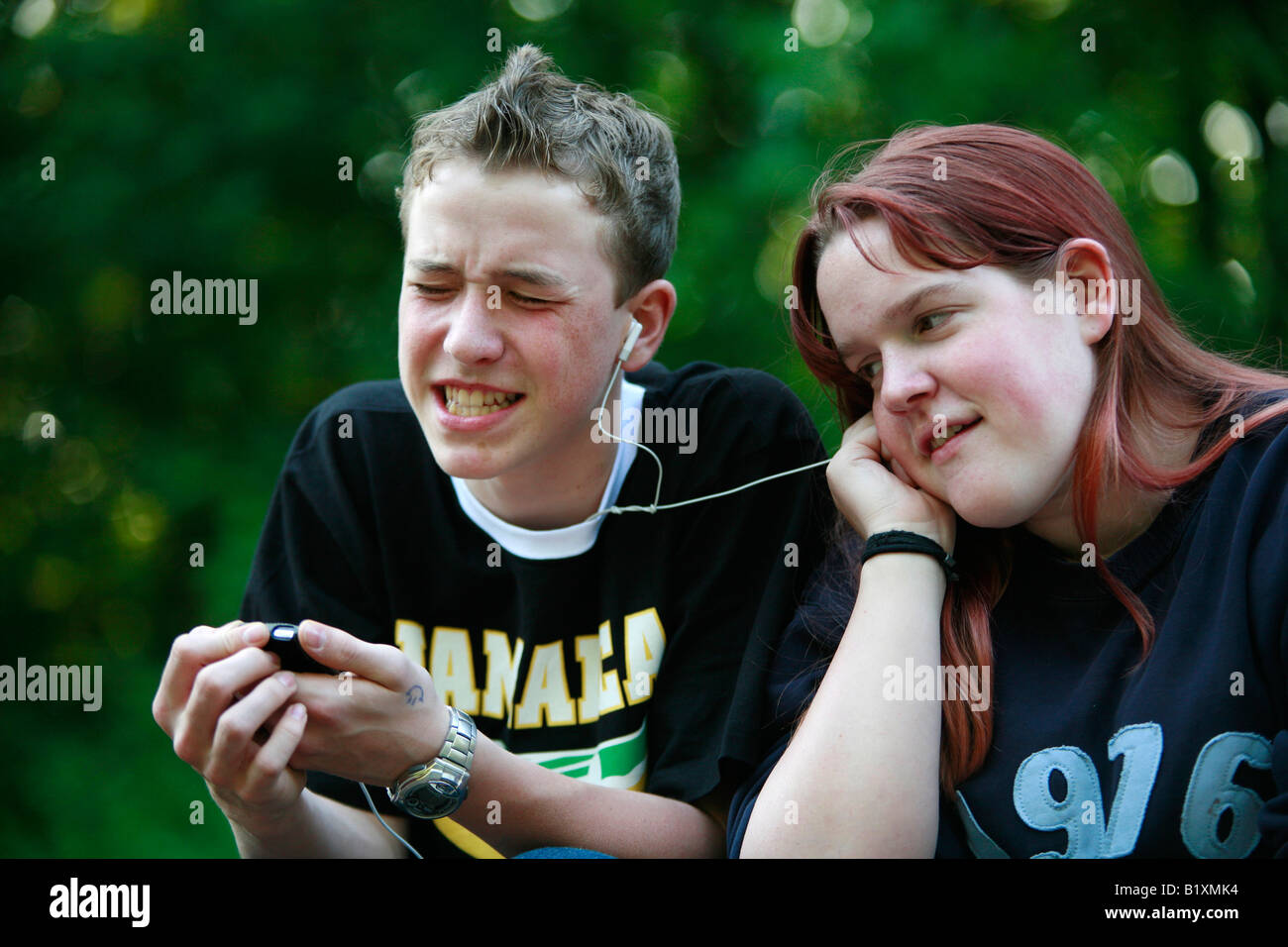 boy and girl listening to music together Stock Photo