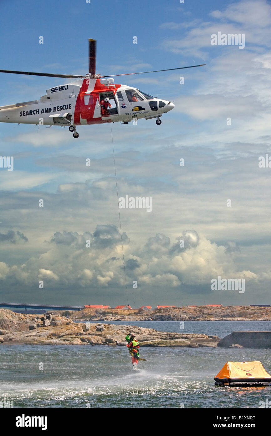 Search and rescue SAR helicopter team hoists a person by help of rescue ...