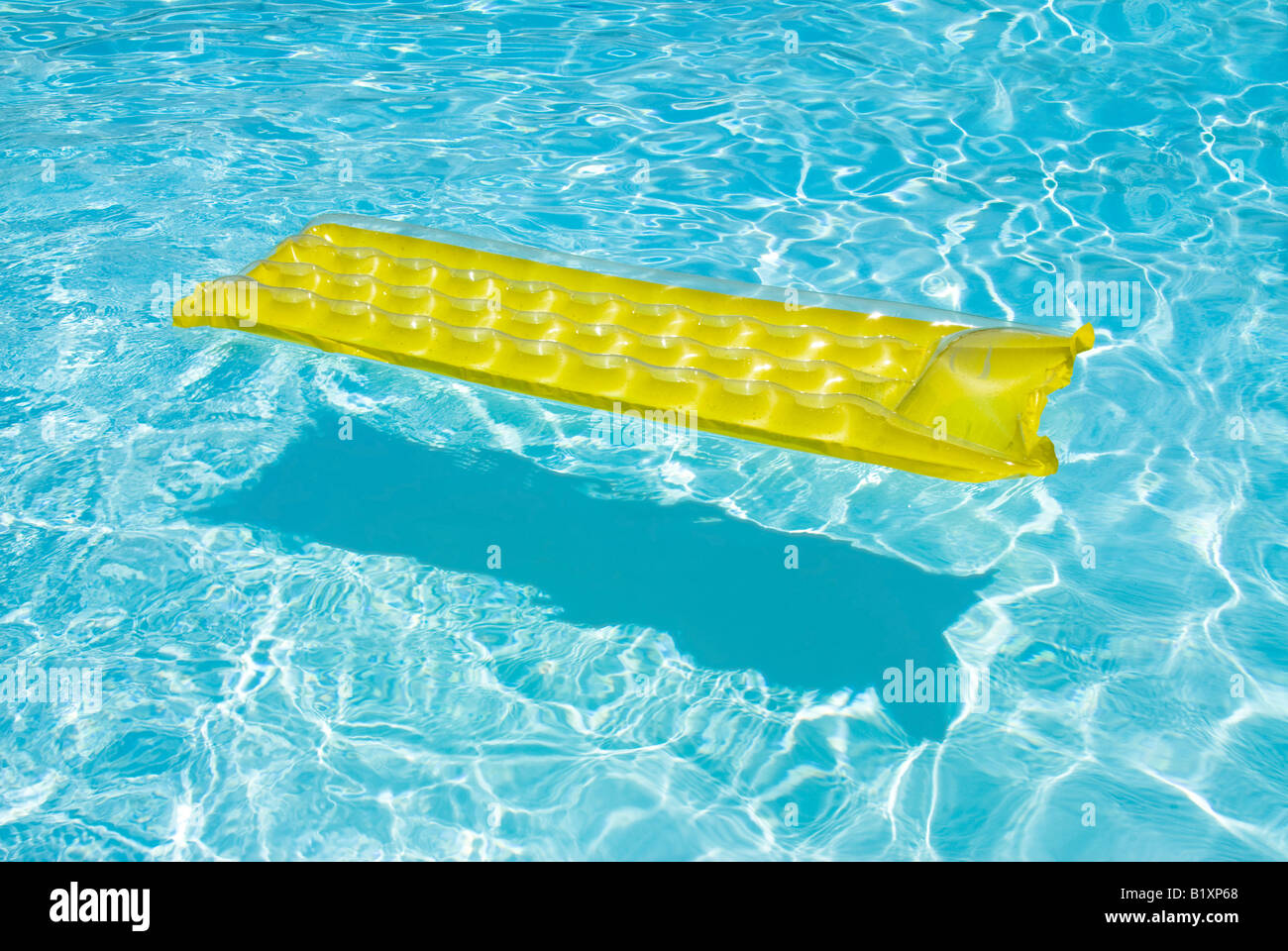 A yellow raft floats in a swimming pool Stock Photo Alamy