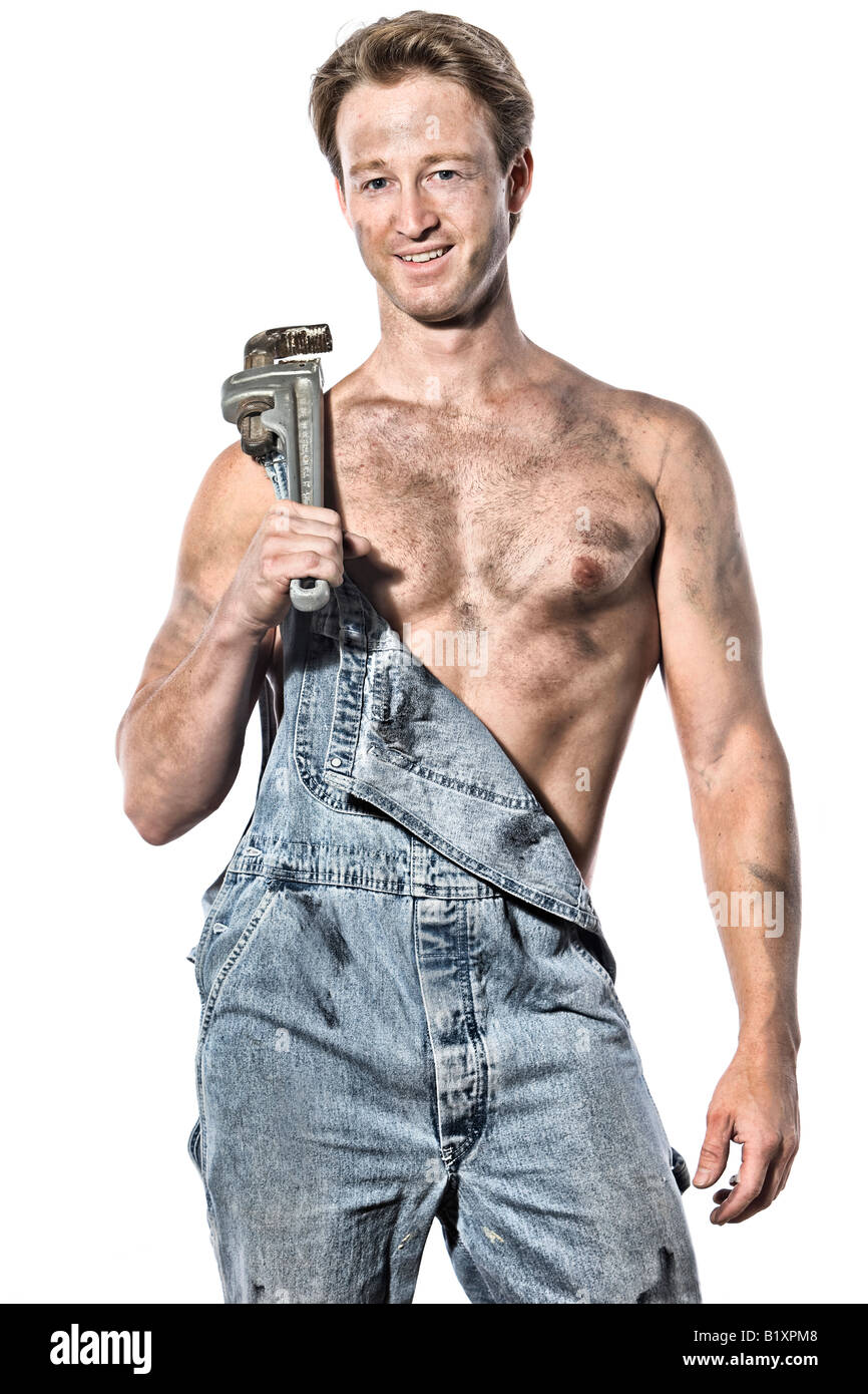 Sexy greasy caucasian man 30 something handyman plumber with his tools  wrench wearing bib jeans Stock Photo - Alamy